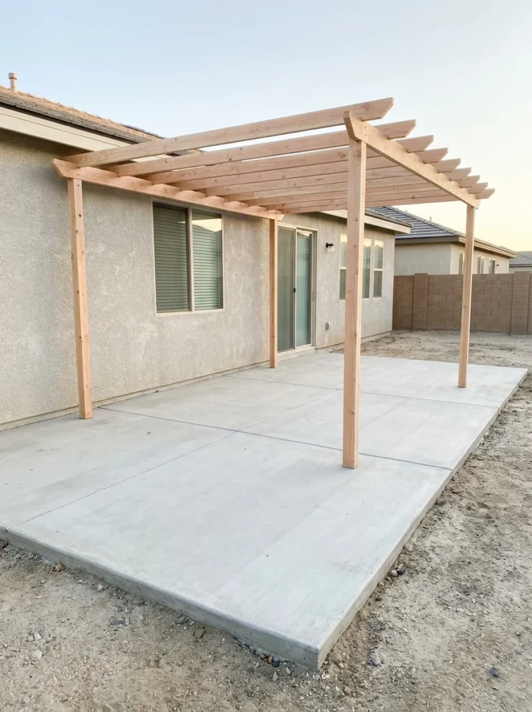Affordable backyard makeover completed gradually with furniture, plants, and lighting.