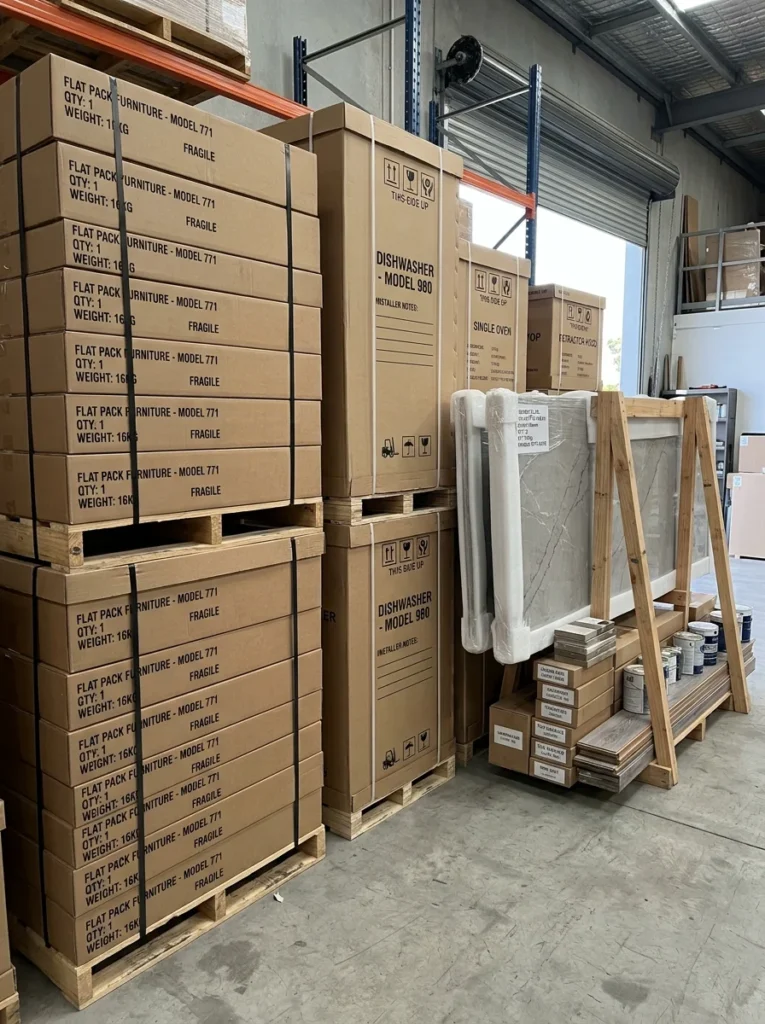 Kitchen cabinets, countertops, and renovation materials waiting for installation.