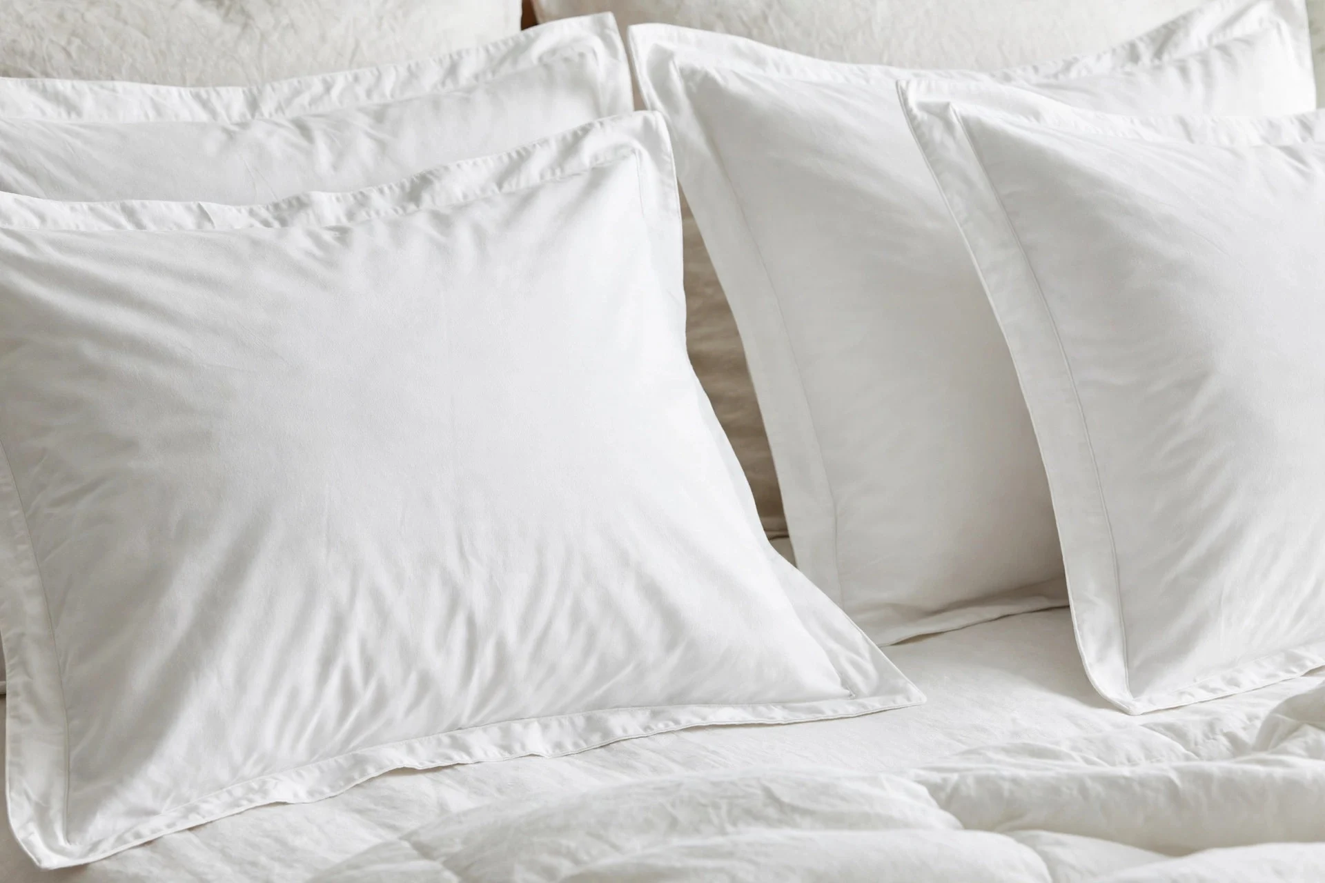 Matching shams with a bordered edge on king bed pillows.